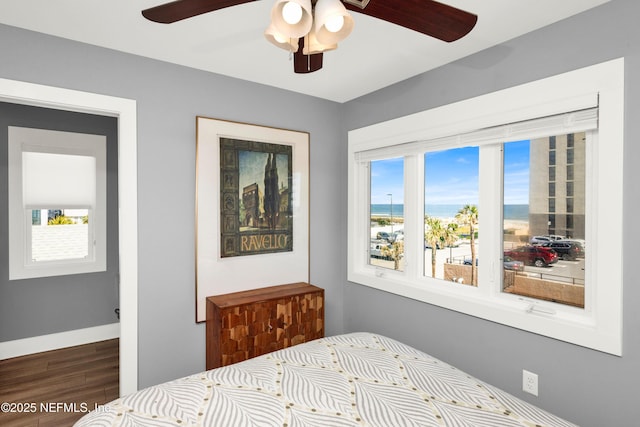 1306 1st St S, Jacksonville Beach, FL 32250 - bedroom with multiple windows, a ceiling fan, baseboards, and wood finished floors