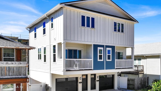 1308 1st St S, Jacksonville Beach, FL 32250 - view of front facade with fence, a garage, and board and batten siding
