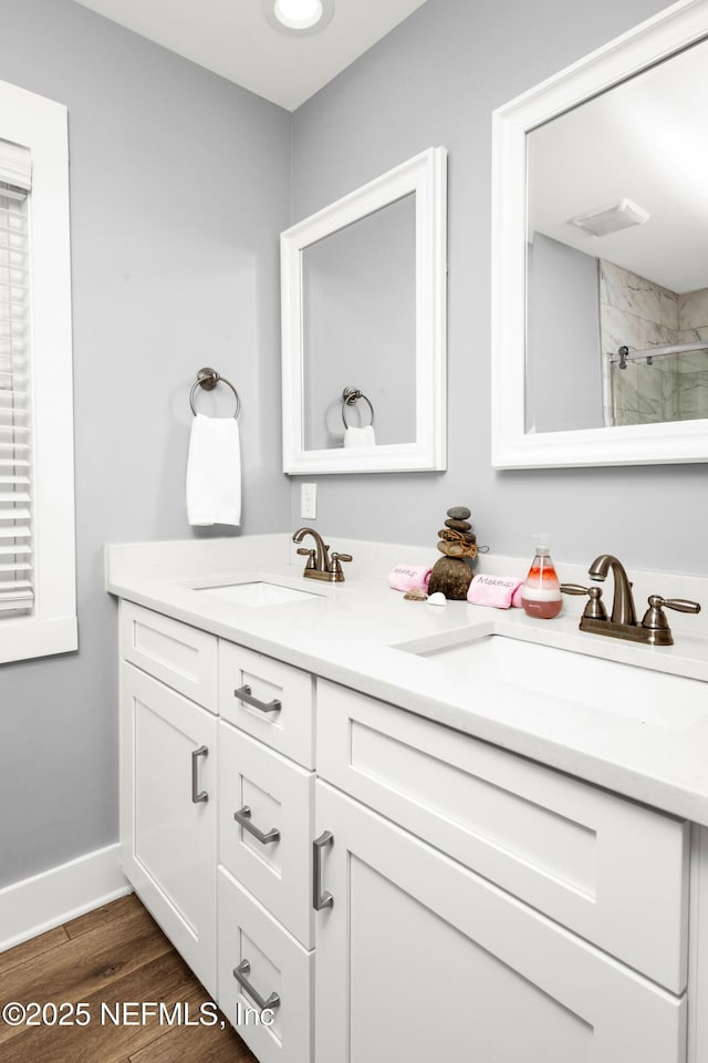 1308 1st St S, Jacksonville Beach, FL 32250 - bathroom featuring double vanity, a sink, walk in shower, and wood finished floors