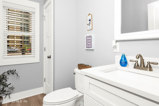 1308 1st St S, Jacksonville Beach, FL 32250 - bathroom featuring baseboards, toilet, vanity, and wood finished floors