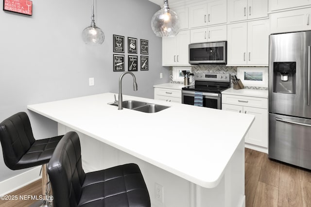 1308 1st St S, Jacksonville Beach, FL 32250 - kitchen featuring a sink, white cabinetry, appliances with stainless steel finishes, decorative backsplash, and dark wood-style flooring