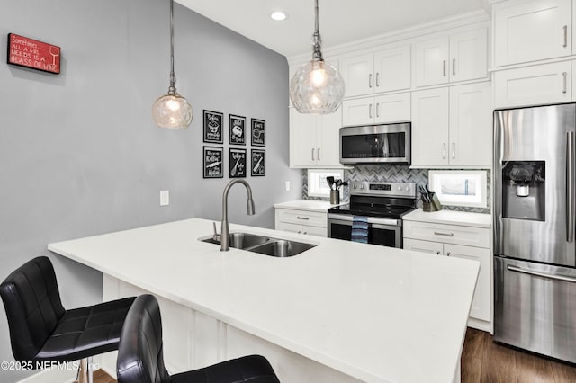 1308 1st St S, Jacksonville Beach, FL 32250 - kitchen with a sink, white cabinetry, tasteful backsplash, appliances with stainless steel finishes, and dark wood-style floors