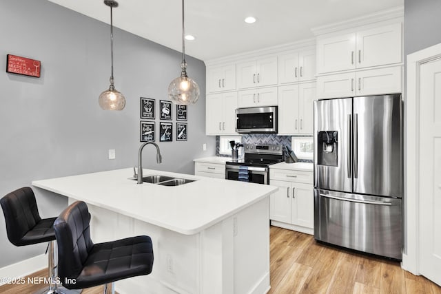 1308 1st St S, Jacksonville Beach, FL 32250 - kitchen featuring white cabinetry, a sink, stainless steel appliances, and light wood-type flooring