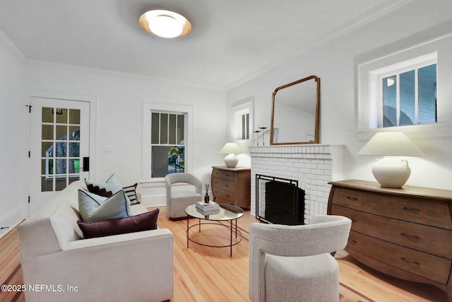 living room with light wood-type flooring, a brick fireplace, and crown molding