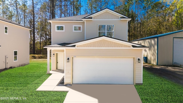 view of front of house with a garage, concrete driveway, and a front lawn