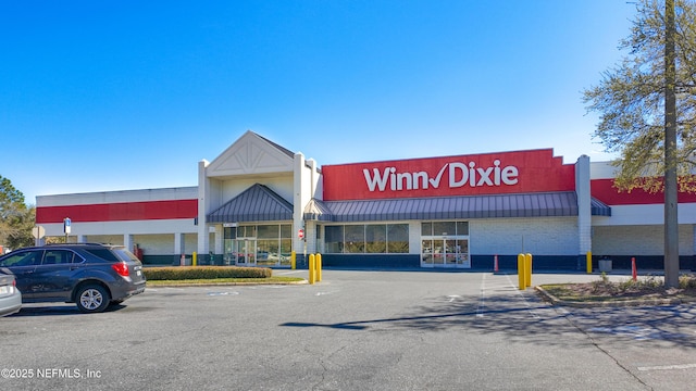 view of building exterior featuring uncovered parking