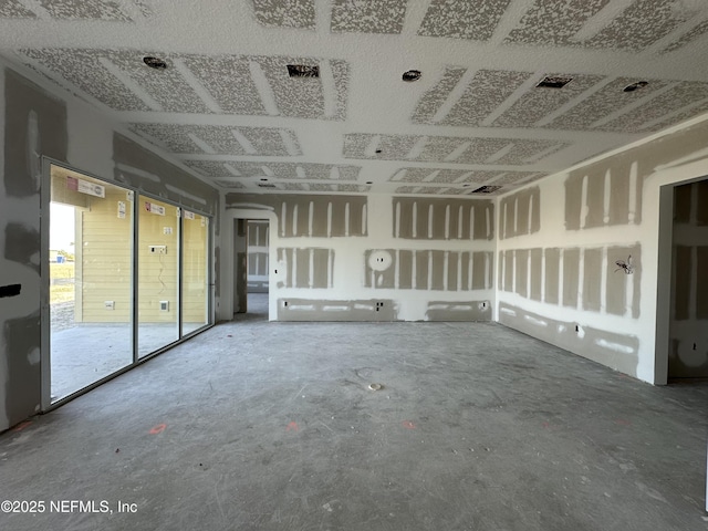 unfurnished living room with a garage