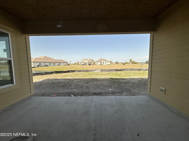 view of yard featuring a residential view and a patio