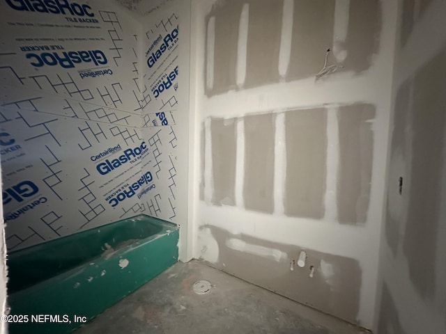 bathroom with unfinished concrete flooring