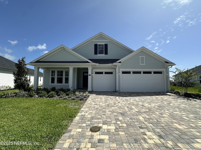 123 Tesoro Ter, Saint Augustine, FL 32095 - view of front facade with decorative driveway, a front yard, a garage, and covered porch