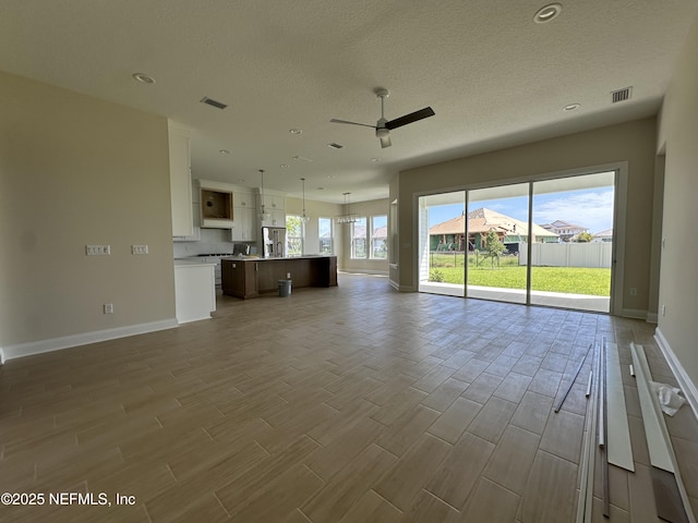 123 Tesoro Ter, Saint Augustine, FL 32095 - unfurnished living room with wood tiled floors, a ceiling fan, recessed lighting, and a textured ceiling