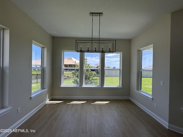 123 Tesoro Ter, Saint Augustine, FL 32095 - unfurnished dining area with dark wood finished floors and a textured ceiling