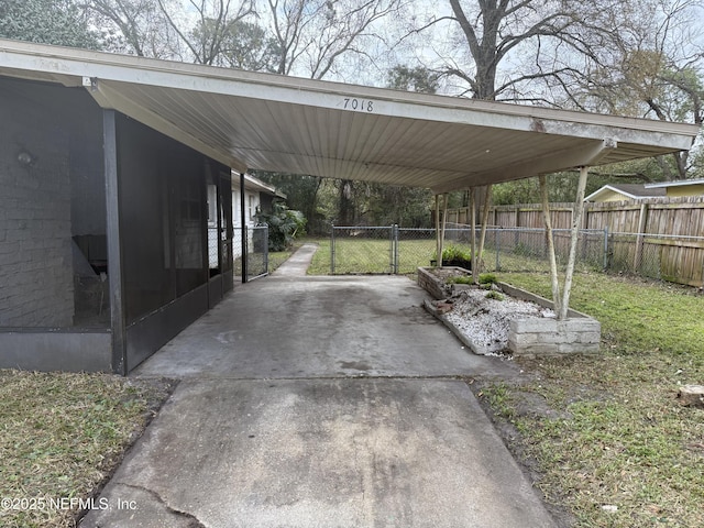 view of parking featuring driveway and fence