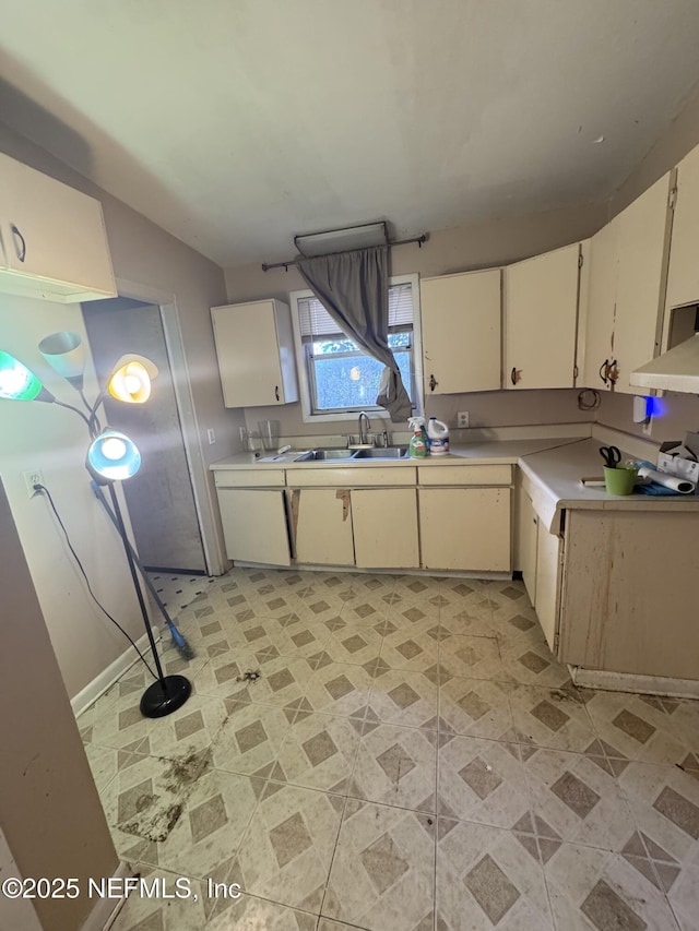 kitchen with light countertops and a sink