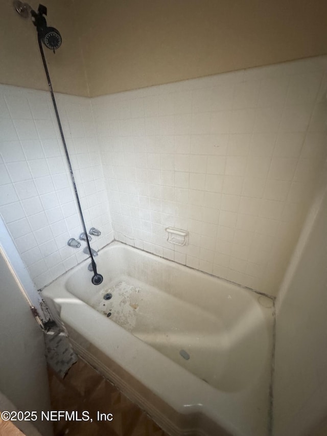 bathroom featuring a washtub and a shower