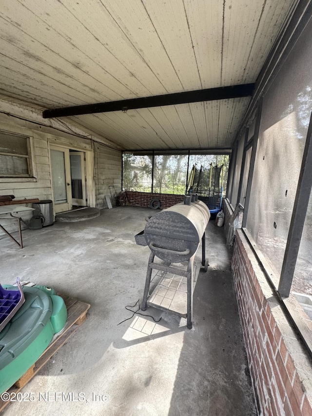 unfurnished sunroom with lofted ceiling