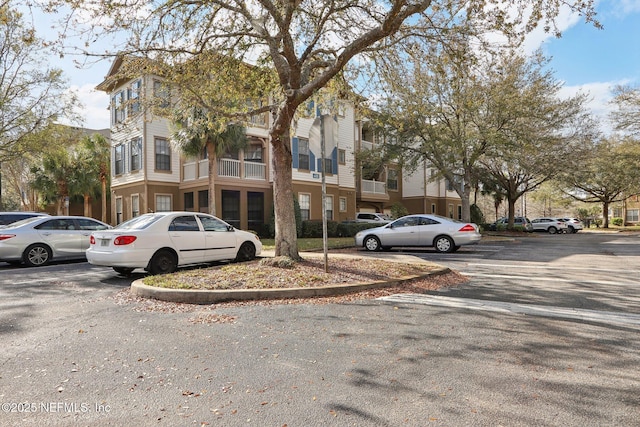 view of property featuring uncovered parking