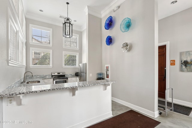 kitchen with crown molding, light stone countertops, a peninsula, and appliances with stainless steel finishes