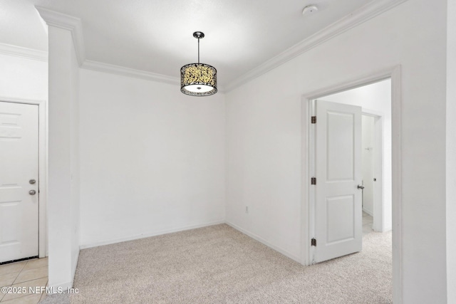 empty room with light colored carpet, baseboards, and ornamental molding