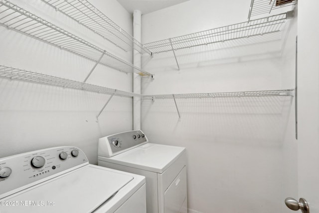 laundry room with laundry area and washing machine and clothes dryer