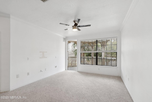 empty room with ceiling fan, carpet, and ornamental molding