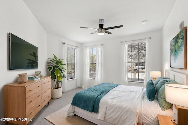 bedroom featuring light colored carpet and ceiling fan