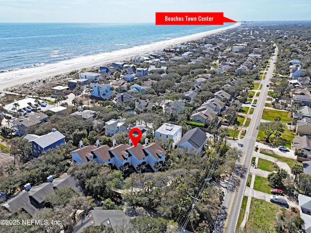 birds eye view of property featuring a water view, a residential view, and a view of the beach