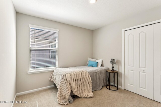 bedroom featuring carpet floors, a closet, and baseboards