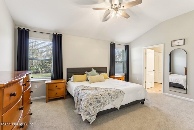 bedroom featuring baseboards, vaulted ceiling, a ceiling fan, and light colored carpet