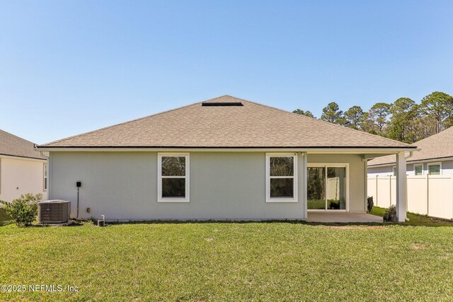 rear view of house featuring a patio, a yard, fence, and central air condition unit