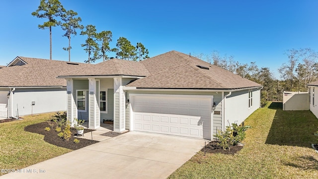 view of front of house featuring a garage, a front yard, concrete driveway, and a shingled roof