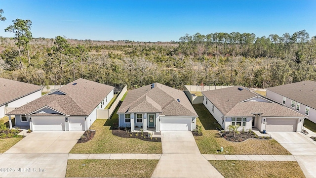 birds eye view of property with a forest view and a residential view