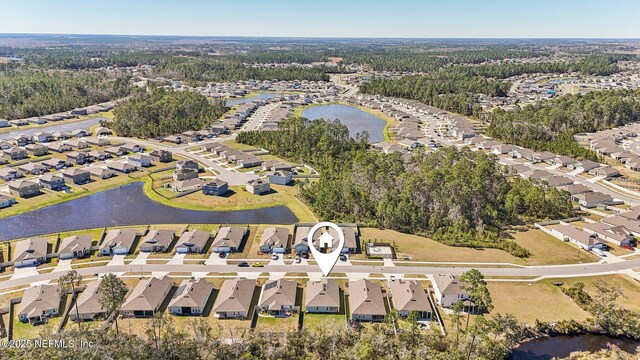 drone / aerial view featuring a water view and a residential view