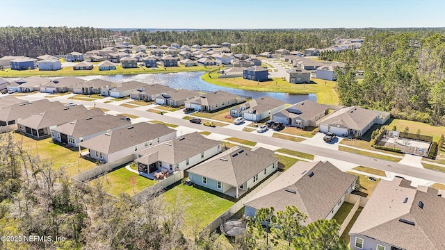 birds eye view of property with a residential view and a water view