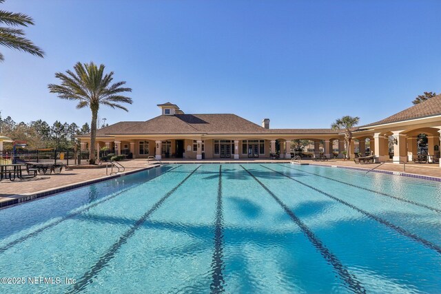 pool featuring a patio and fence