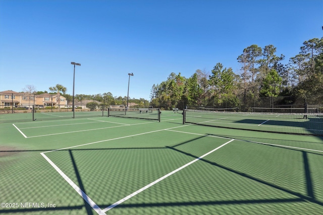 view of sport court featuring fence