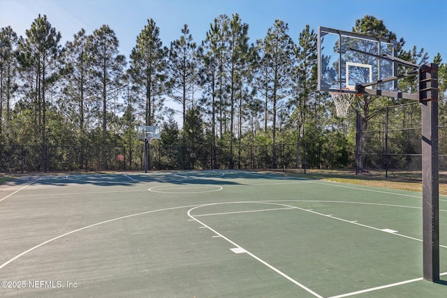 view of basketball court featuring community basketball court and fence