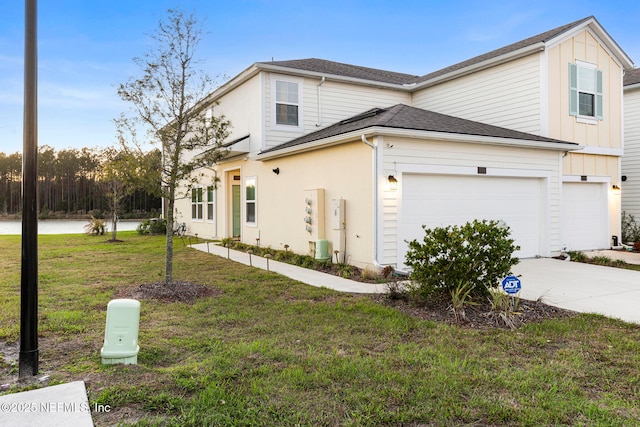 exterior space with board and batten siding, concrete driveway, a yard, and a shingled roof