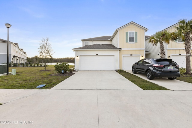 439 Coastline Way, Saint Augustine, FL 32092 - view of front of property featuring concrete driveway, a shingled roof, board and batten siding, and a front yard