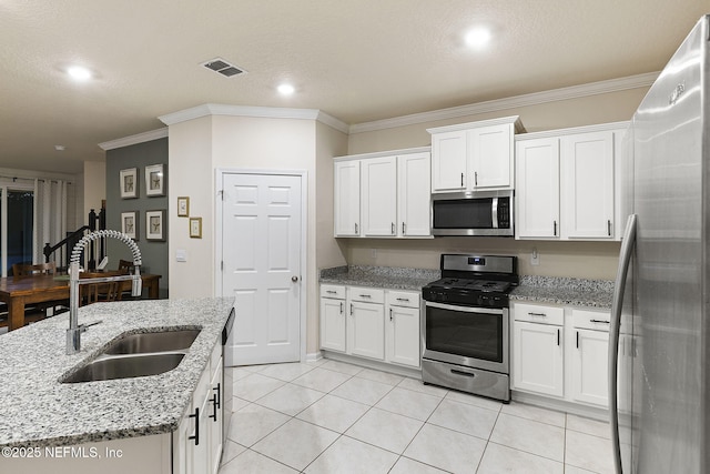 439 Coastline Way, Saint Augustine, FL 32092 - kitchen with appliances with stainless steel finishes, white cabinets, visible vents, and a sink