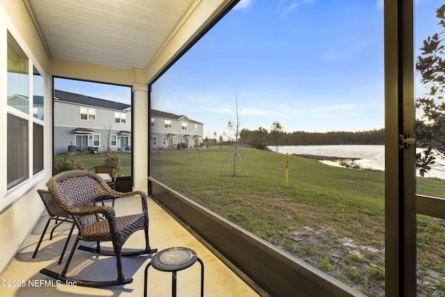 sunroom / solarium featuring a water view