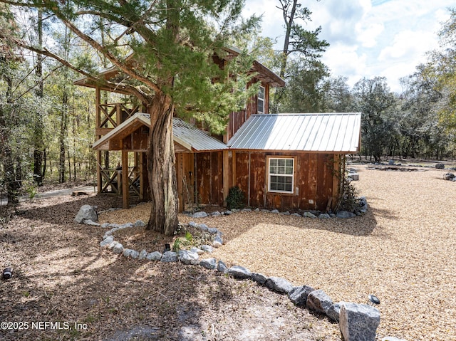 view of home's exterior with metal roof and board and batten siding