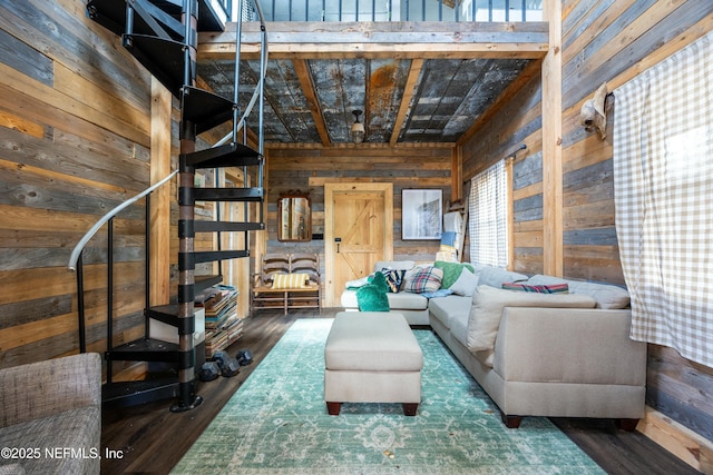 living room with wood walls, stairs, and wood finished floors