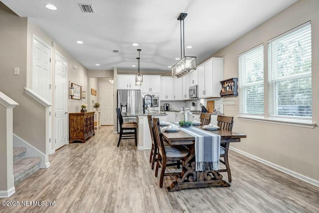 6743 Summit Vista Ct, Jacksonville, FL 32259 - dining space featuring stairs, light wood finished floors, visible vents, and baseboards