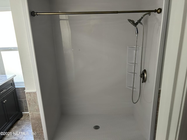 bathroom featuring vanity, tile patterned floors, and a shower