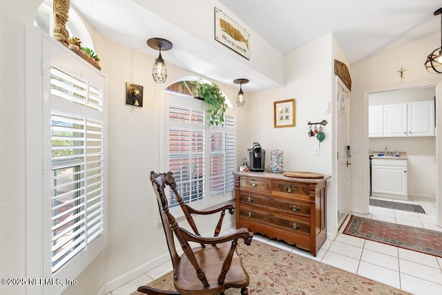 sitting room featuring light tile patterned flooring and baseboards