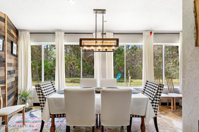 dining space featuring a chandelier and a textured ceiling