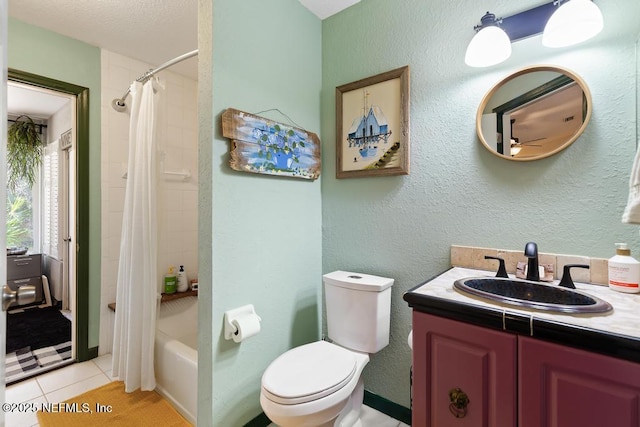 full bathroom with a textured wall, toilet, shower / bath combo with shower curtain, vanity, and tile patterned floors