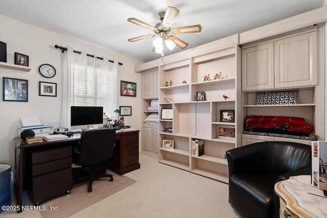 office with a ceiling fan and light colored carpet