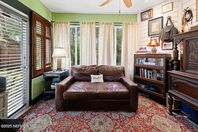 living area featuring a ceiling fan